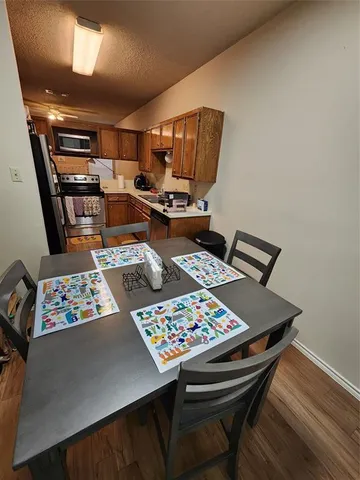 a living room with hard wood floor furniture and a table