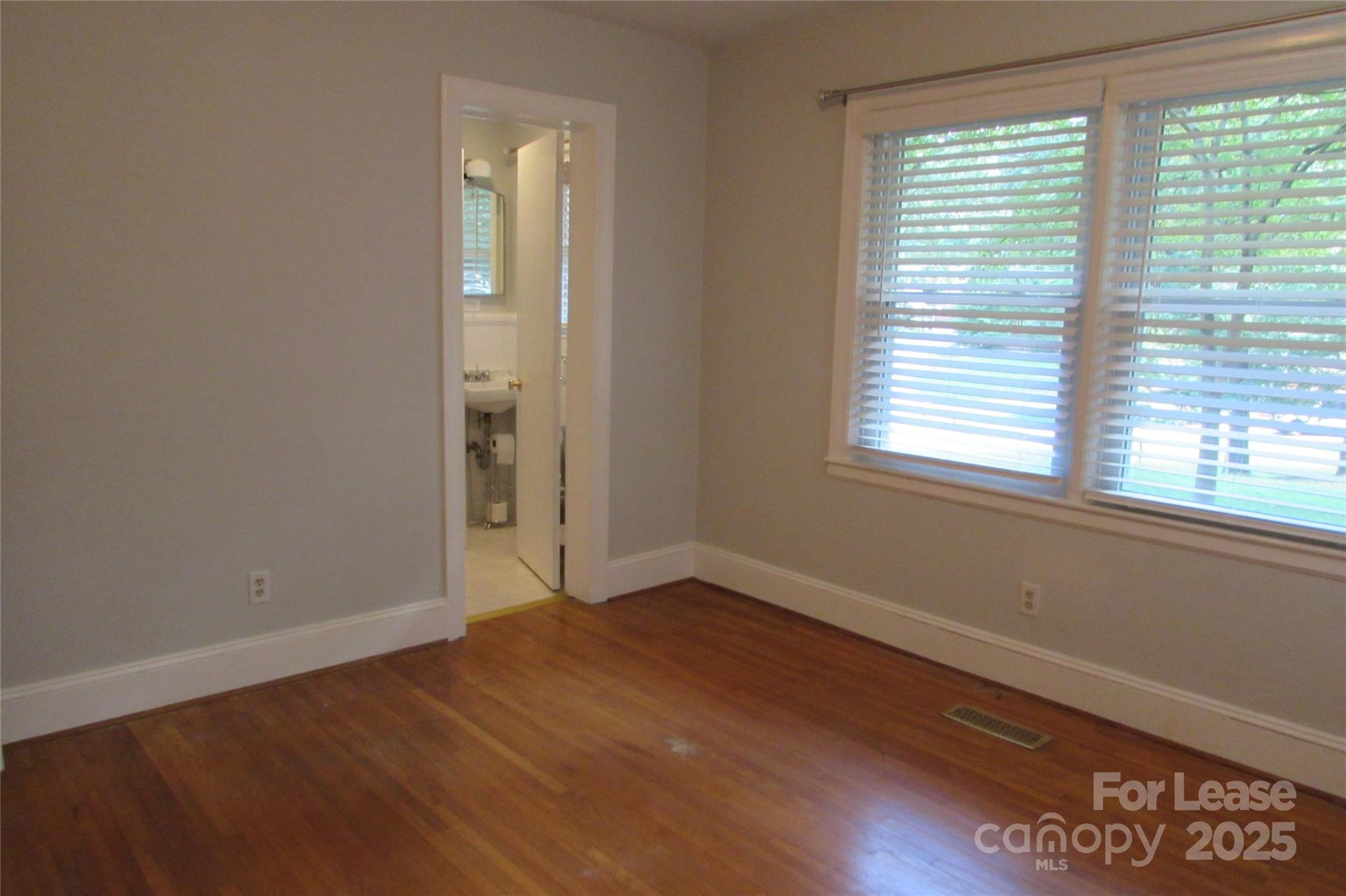 501 Dunham Road Gastonia, NC 28054 - Photo 18 of 28 a view of an empty room with wooden floor and a window