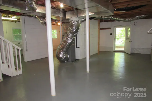 a view of a room with wooden floor