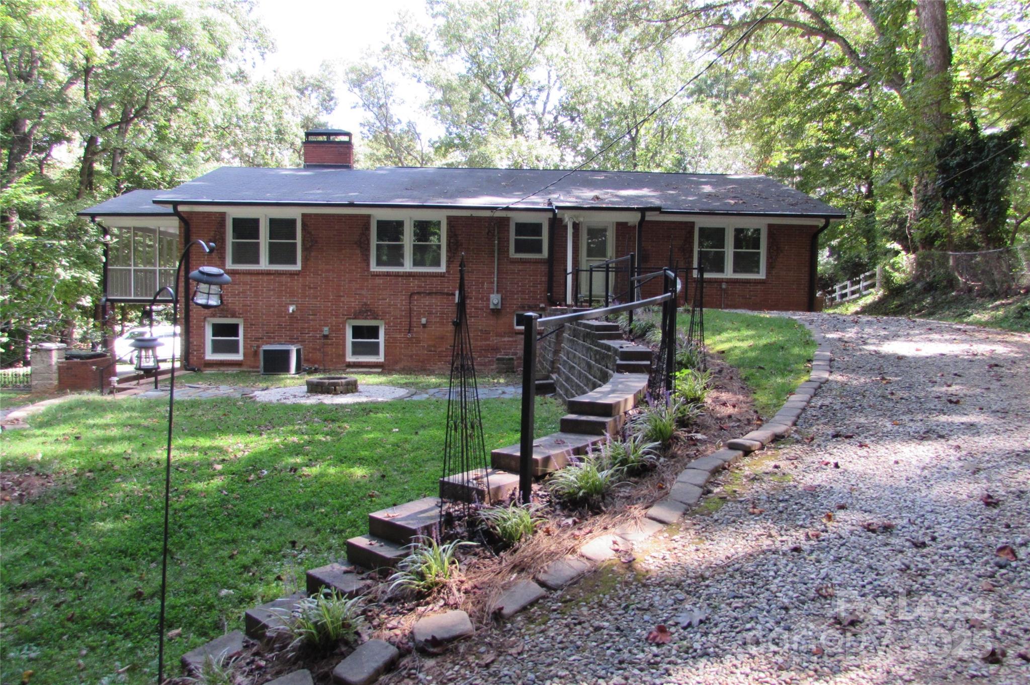 501 Dunham Road Gastonia, NC 28054 - Photo 27 of 28 a view of a house with a yard and lawn chairs