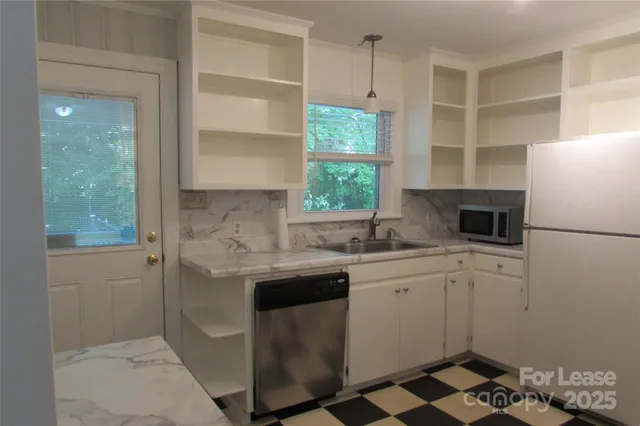 a kitchen with a sink stove and refrigerator