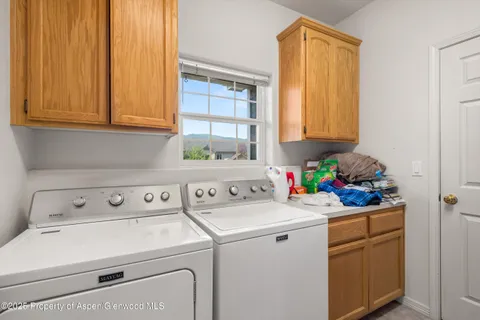 a bedroom with a bed and a flat tv screen on dresser