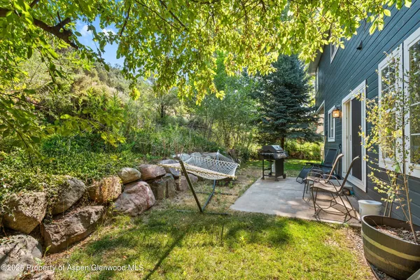 a view of a backyard with sitting area