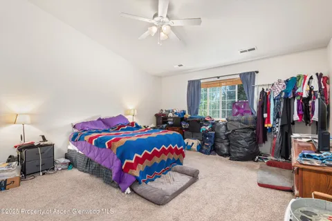 a kitchen with stainless steel appliances granite countertop a stove top oven a sink dishwasher a dining table and chairs with wooden floor