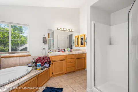 a bedroom with bed and a large window