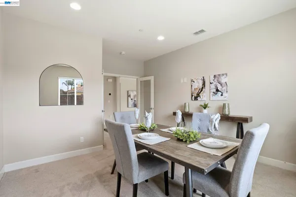a bedroom with two bed computer on desk and a window