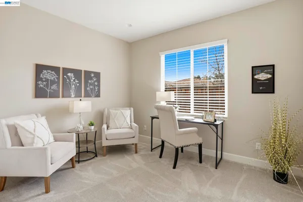 a spacious bedroom with a bed and a large window with balcony view