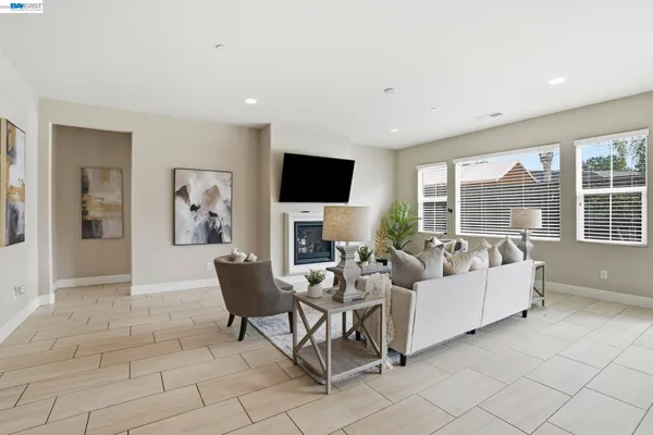 a kitchen with stainless steel appliances granite countertop a stove a sink a dining table and chairs