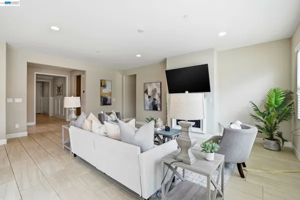 a dining hall with stainless steel appliances granite countertop a sink and a stove