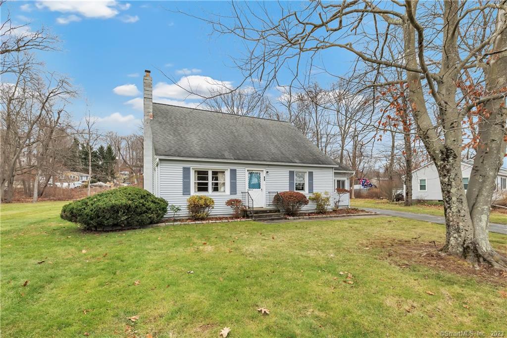 a view of a house with a yard and a fire pit