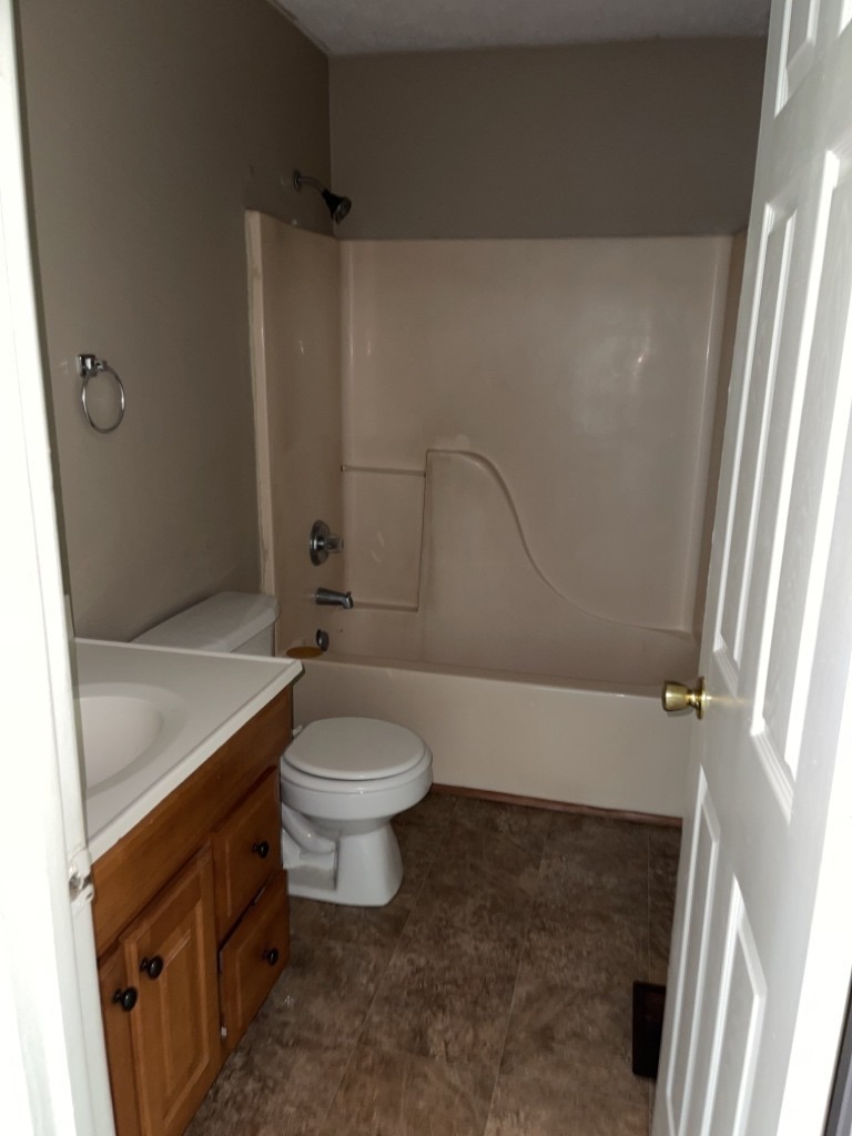523 North Seminary Street Princeton, KY 42445 - Photo 3 of 6 a bathroom with a granite countertop toilet and a sink