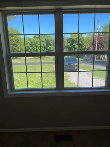 a window that has a wooden table and chairs in it