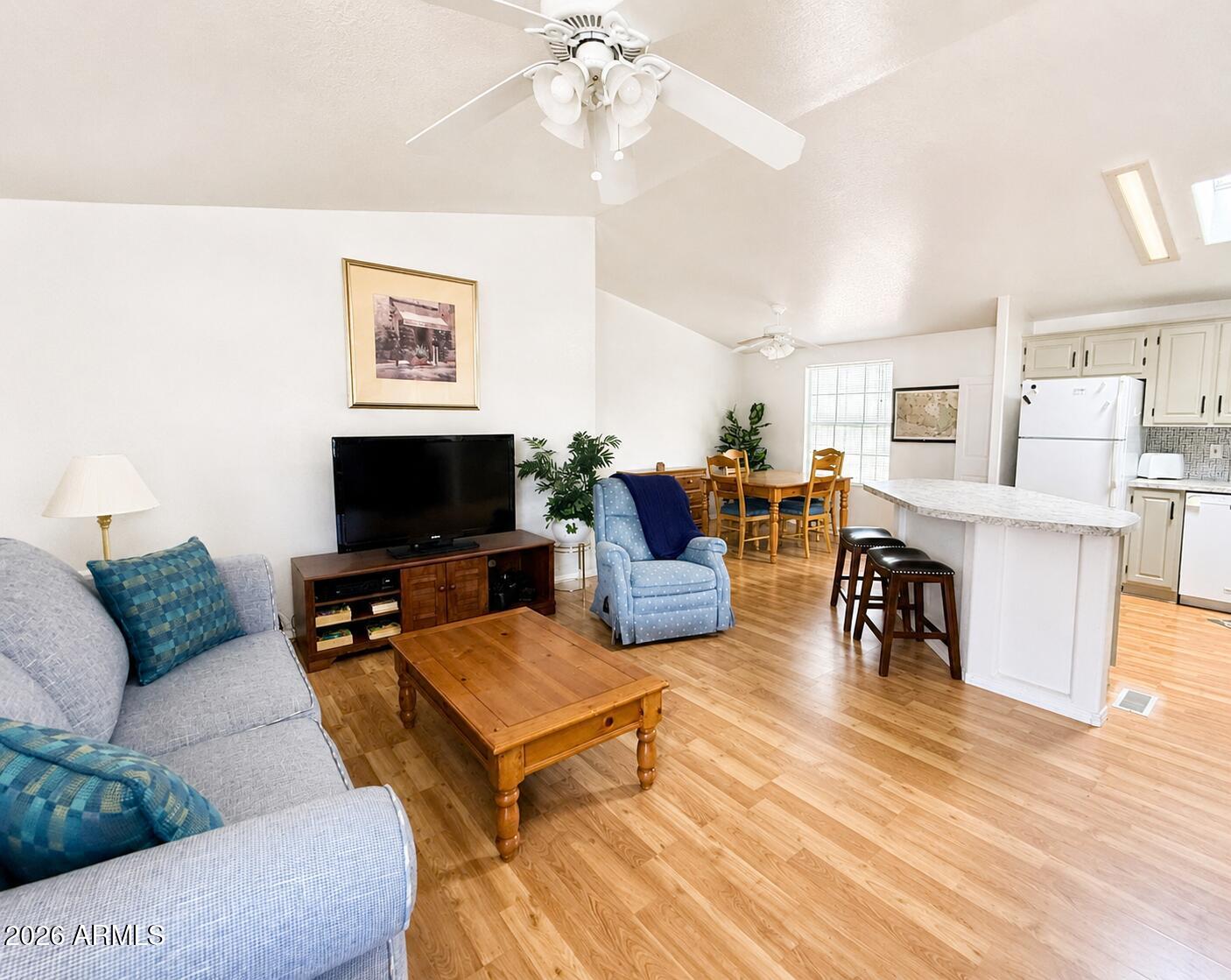 8865 East Baseline Road, Unit 103 Mesa, AZ 85209 - Photo 6 of 47 a living room with furniture kitchen view and a flat screen tv