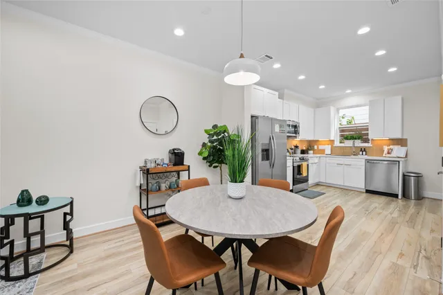 a view of kitchen with cabinets table and chairs