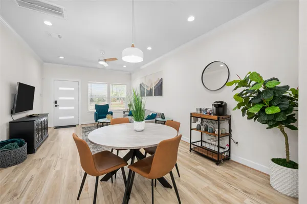 a view of a dining room with furniture and wooden floor