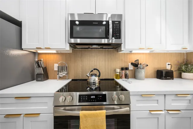a kitchen with a stove and a microwave