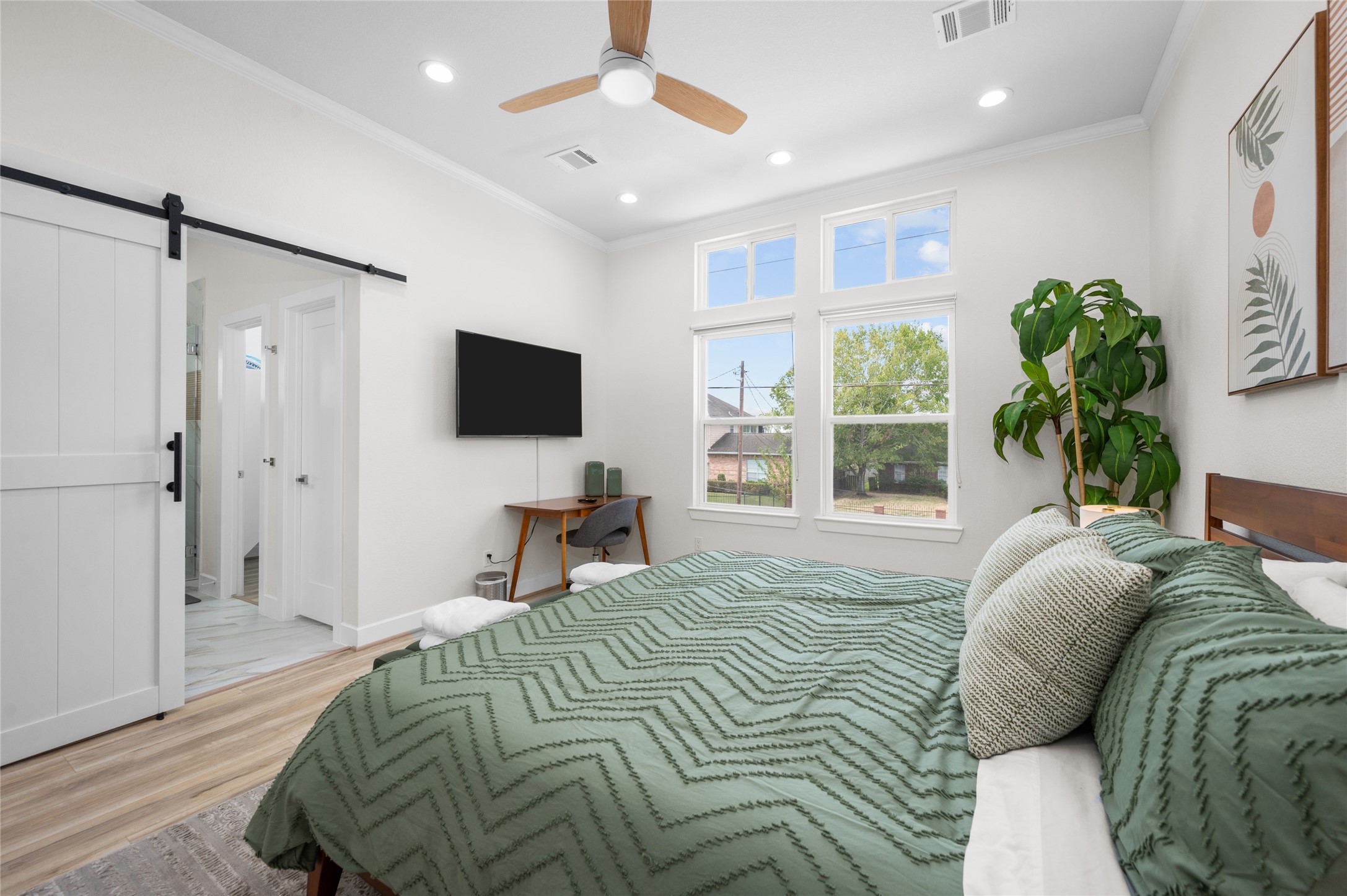 7089 Tierwester Street Houston, TX 77021 - Photo 20 of 35 a bedroom with a bed window and a flat screen tv