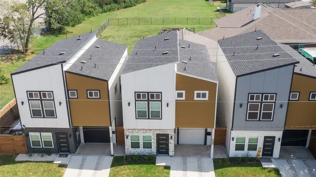 a aerial view of a brick building with many windows next to a yard