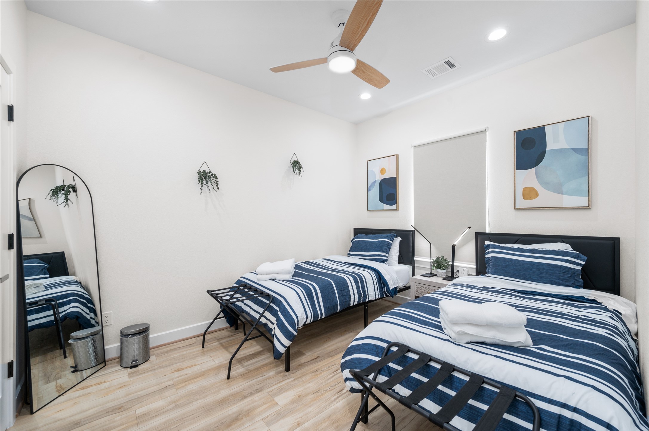 7089 Tierwester Street Houston, TX 77021 - Photo 28 of 35 a bedroom with two beds and wooden floor
