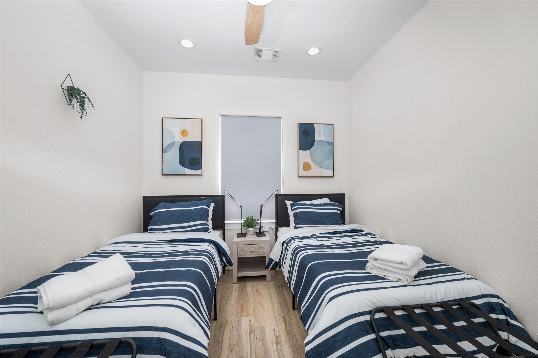 7089 Tierwester Street Houston, TX 77021 - Photo 29 of 35 a bedroom with two beds and painting on the wall