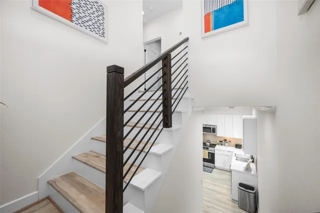 a view of entryway and hall with wooden floor