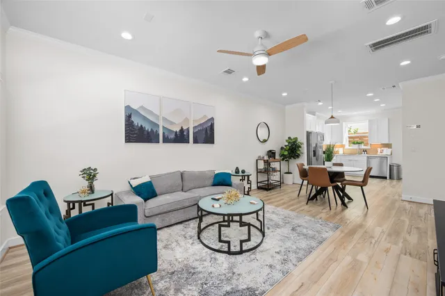 a living room with furniture and kitchen view