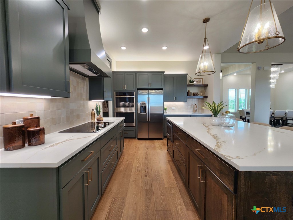 301 Rodeo Road Salado, TX 76571 - Photo 20 of 48 a kitchen with kitchen island granite countertop a sink counter top space a stove and cabinets