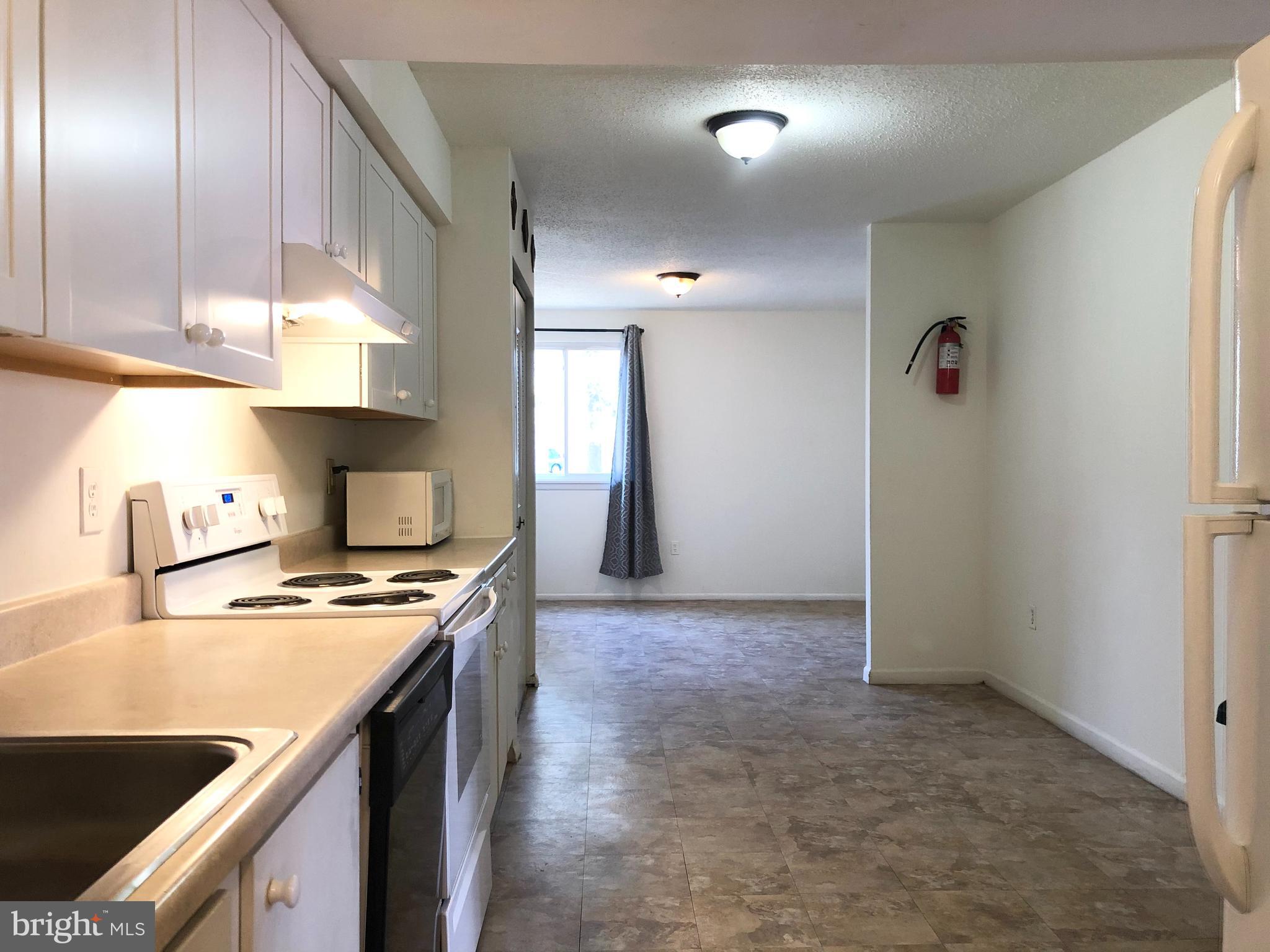 7197 A Cimarron Court Frederick, MD 21703 - Photo 6 of 23 a kitchen with stainless steel appliances granite countertop a sink a stove and a refrigerator