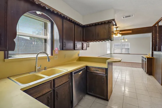 a kitchen with stainless steel appliances granite countertop a sink and cabinets