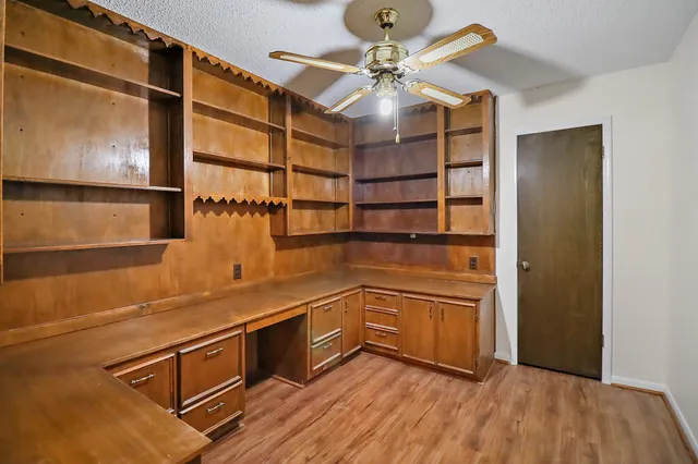 a kitchen with stainless steel appliances granite countertop a cabinets and wooden floor