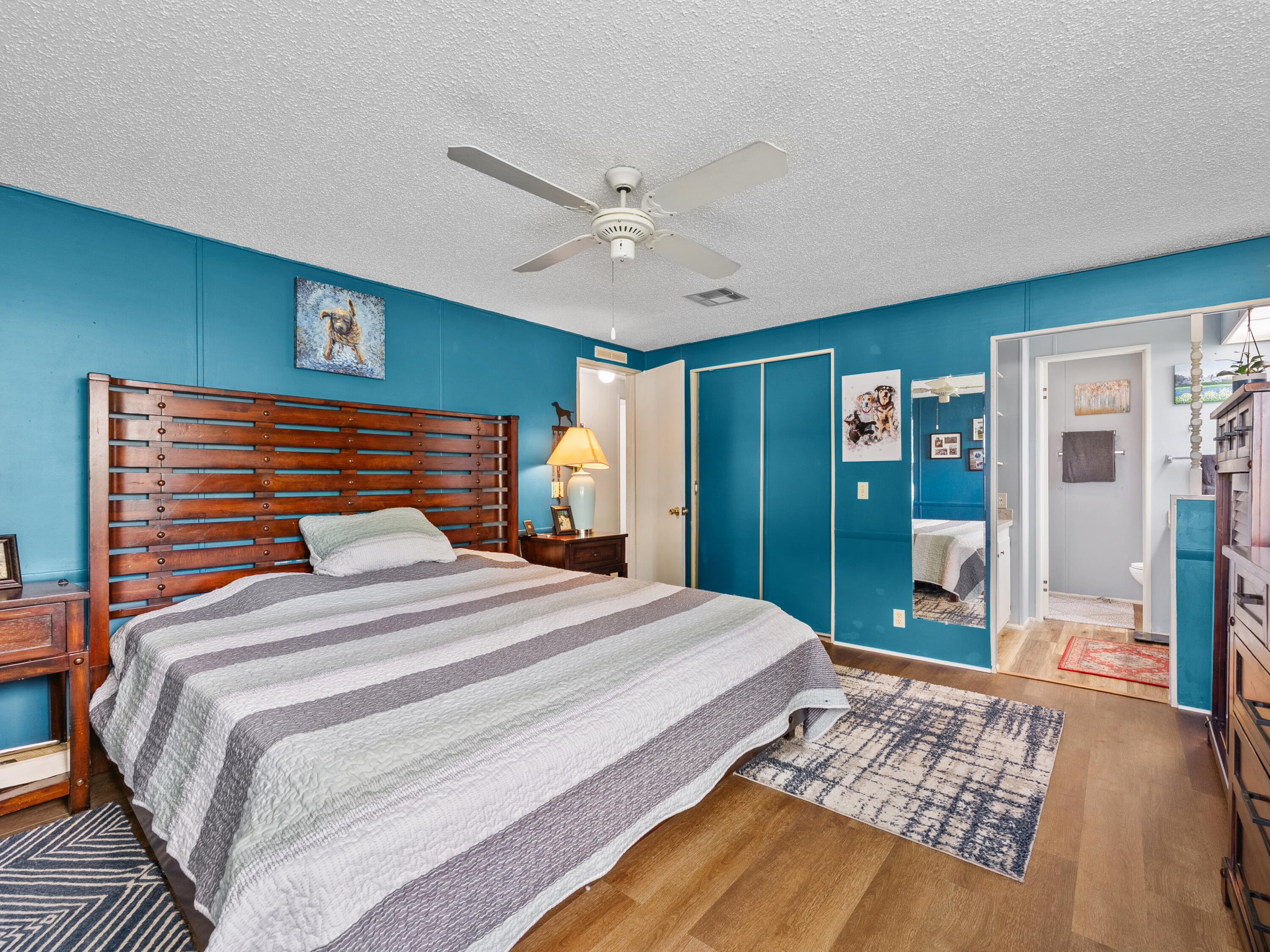 2855 Southwest Monarch Trail Stuart, FL 34997 - Photo 19 of 37 a bedroom with a large bed and a chandelier