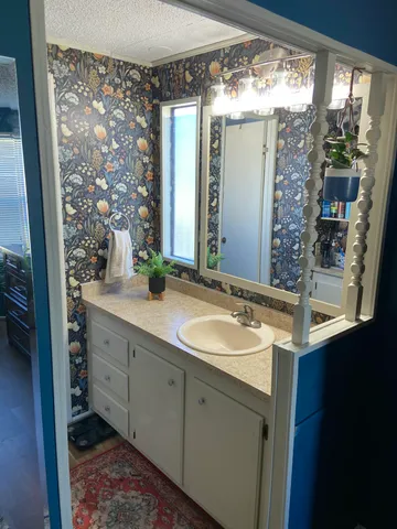 a bathroom with a double vanity sink mirror and shower