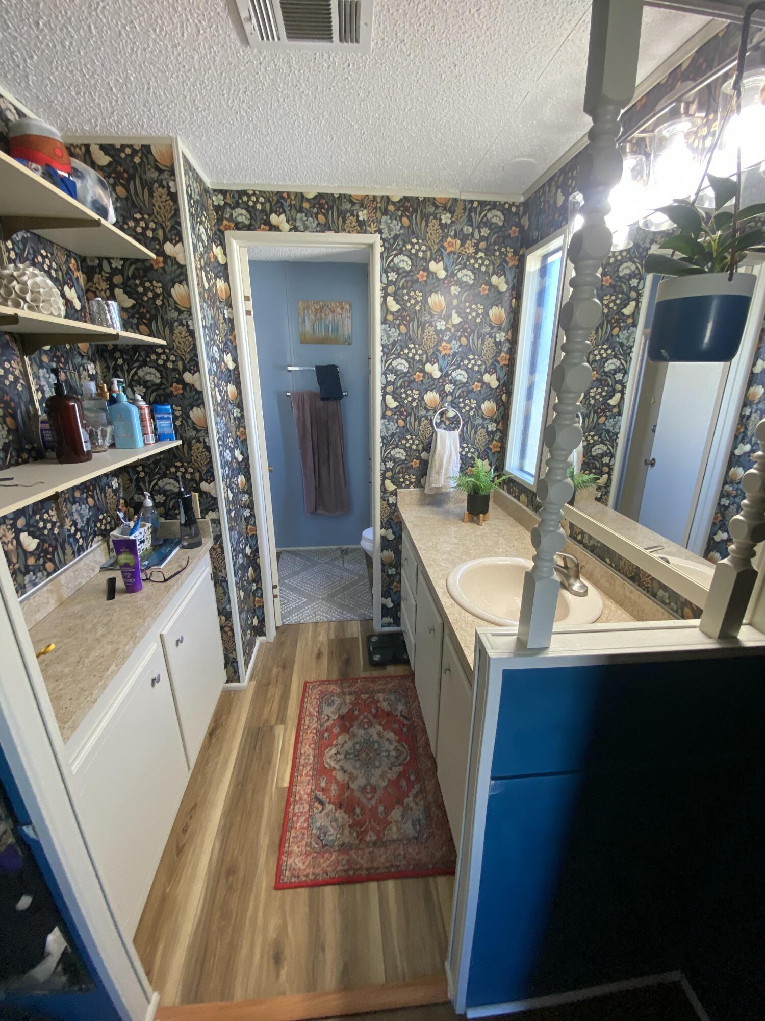 2855 Southwest Monarch Trail Stuart, FL 34997 - Photo 25 of 37 a hallway with a sink a washer and dryer
