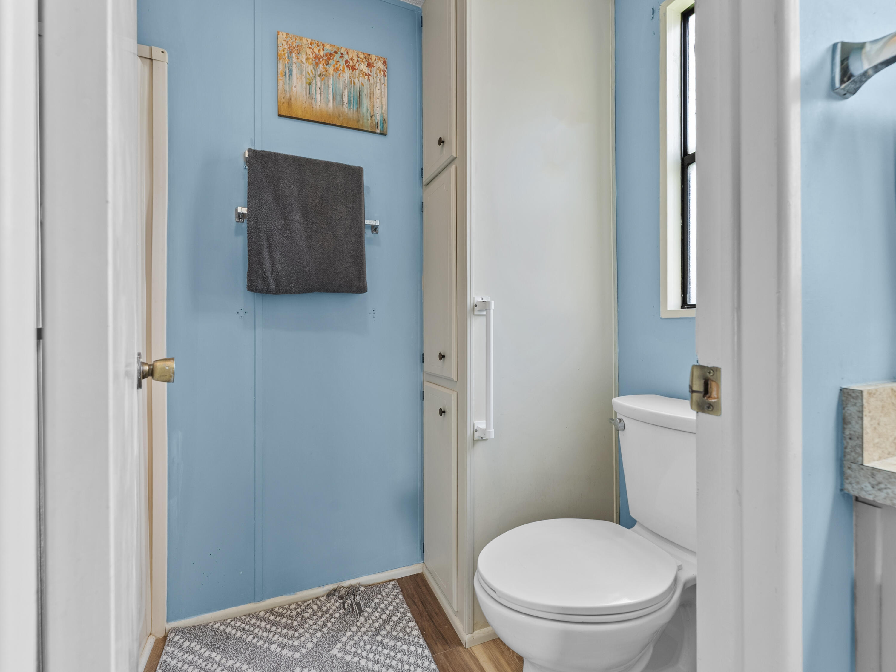 2855 Southwest Monarch Trail Stuart, FL 34997 - Photo 26 of 37 a white toilet sitting next to a bathroom sink