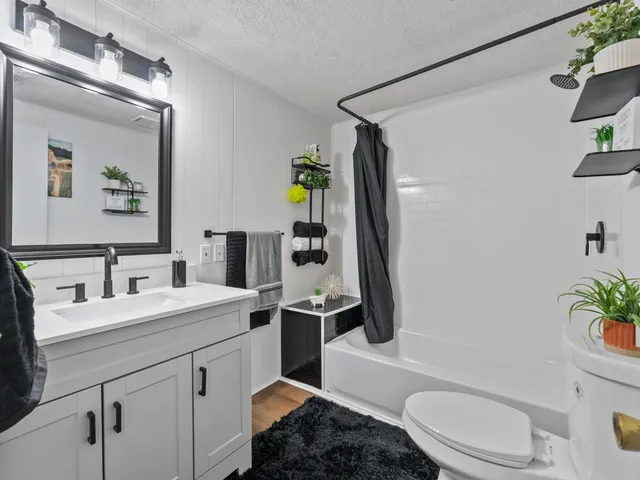 a bathroom with a sink toilet and shower