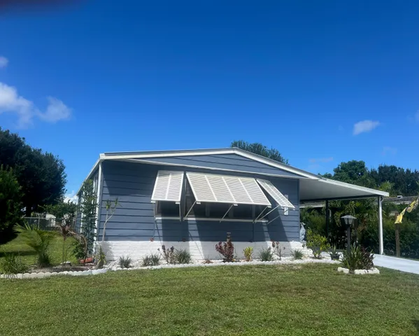 a front view of house with yard slide and outdoor seating