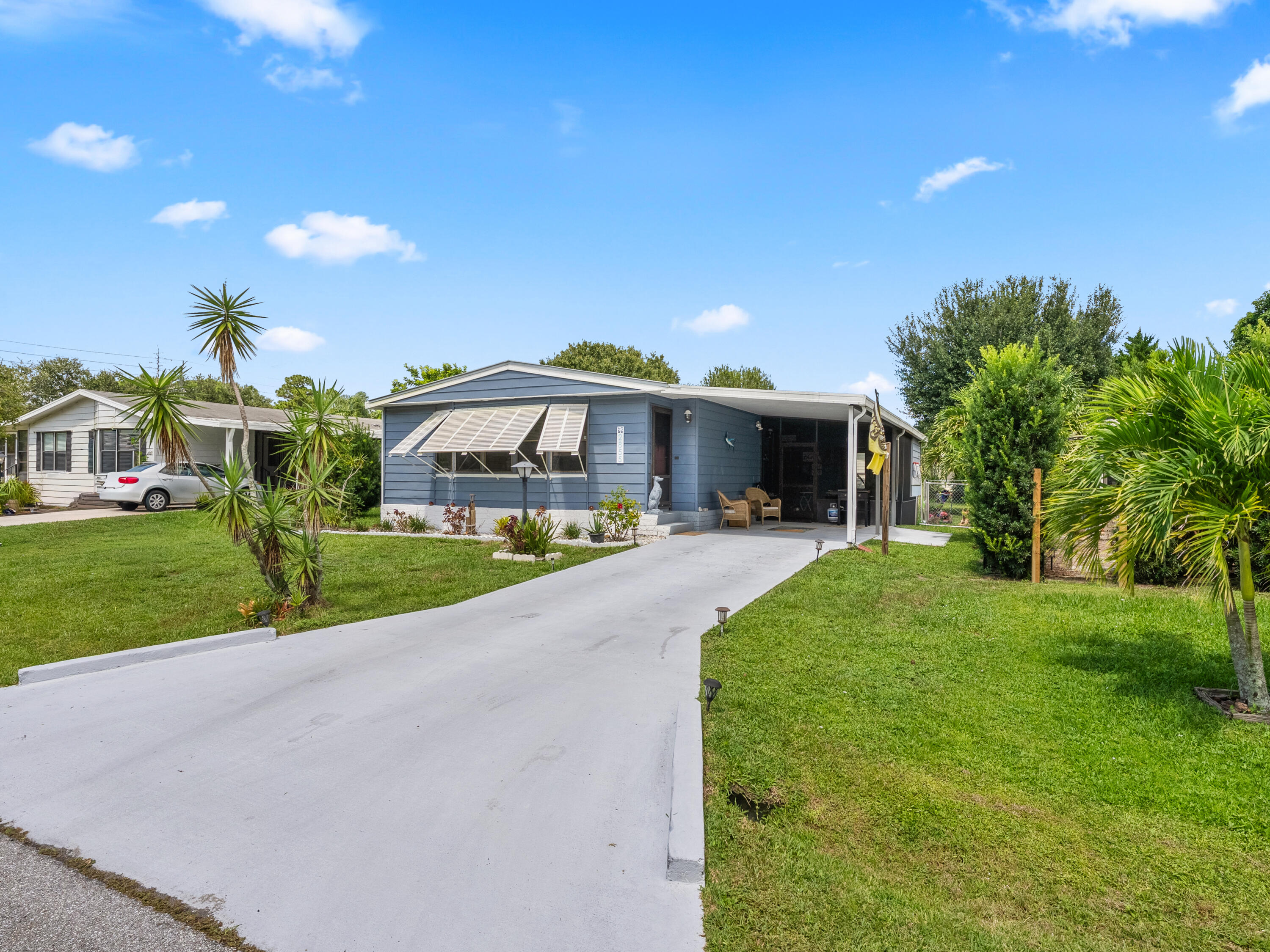 2855 Southwest Monarch Trail Stuart, FL 34997 - Photo 4 of 37 a front view of house with yard and green space