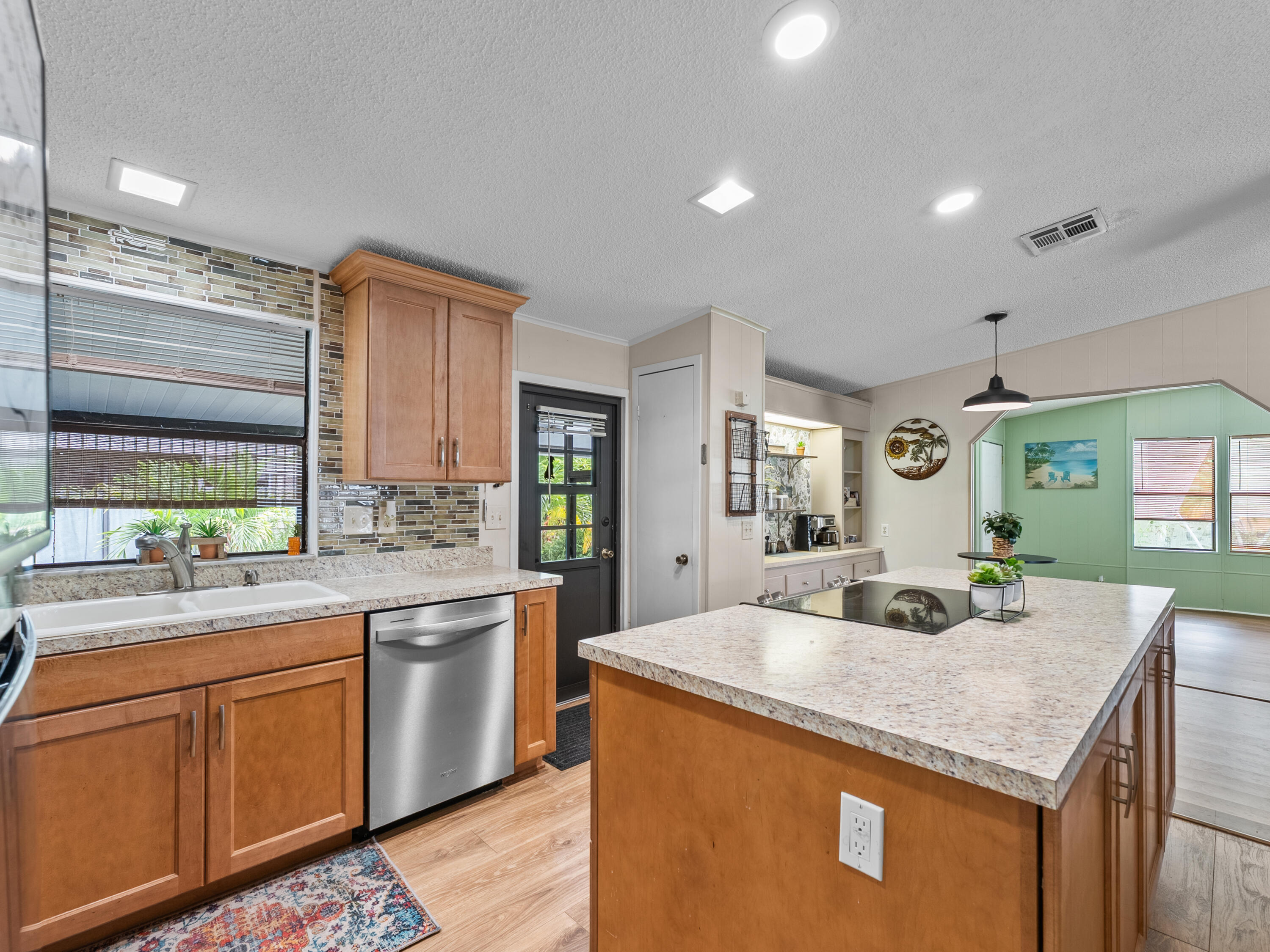 2855 Southwest Monarch Trail Stuart, FL 34997 - Photo 8 of 37 a kitchen with center island and sink