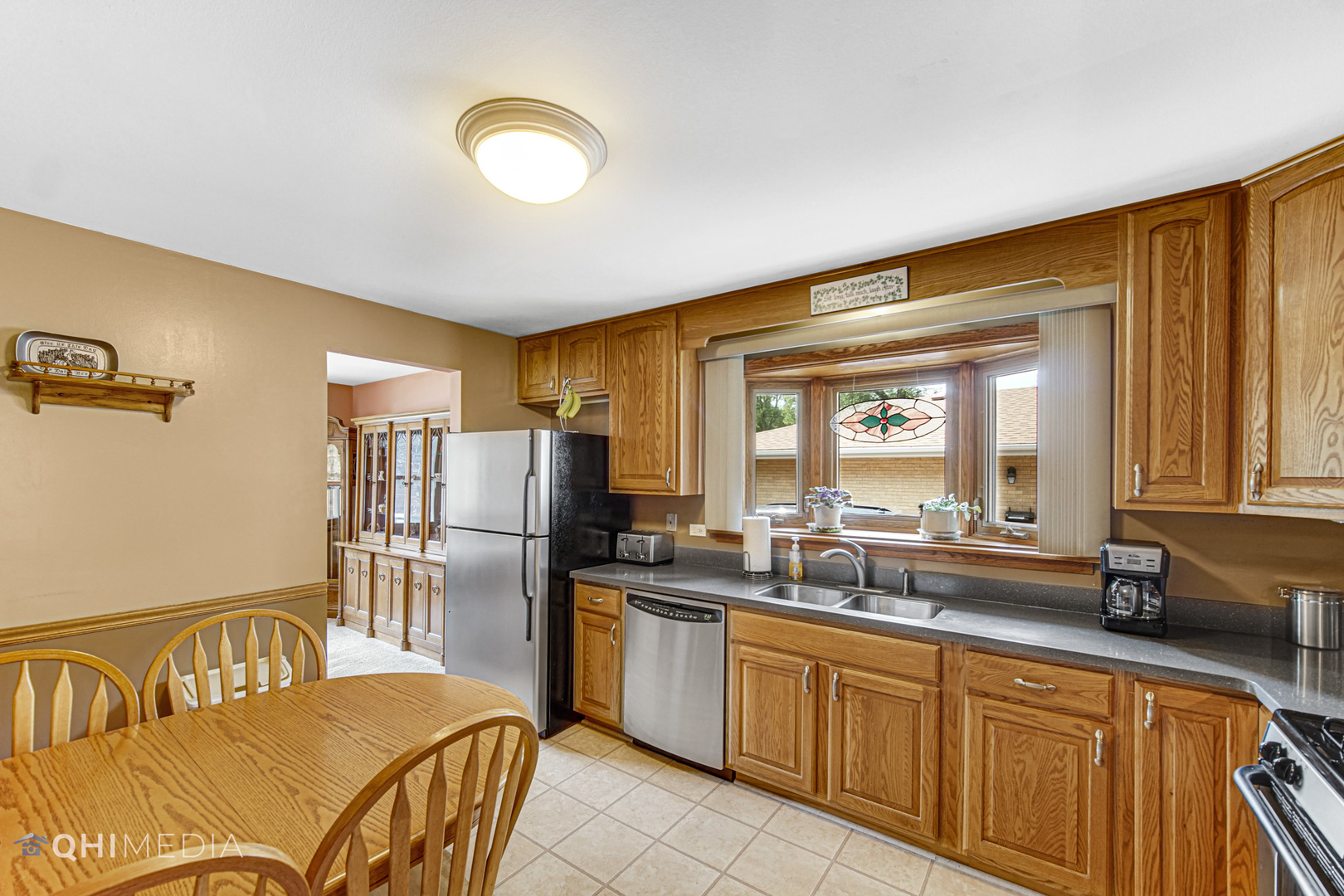 1238 Elder Road Homewood, IL 60430 - Photo 13 of 26 a kitchen with a sink refrigerator and cabinets