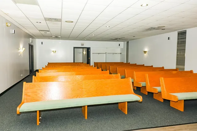a view of a room with gym equipment and wooden floor