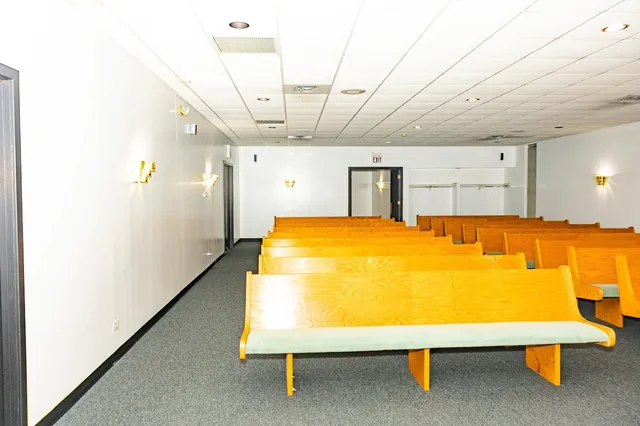 a bathroom with stainless steel appliances a sink and a refrigerator