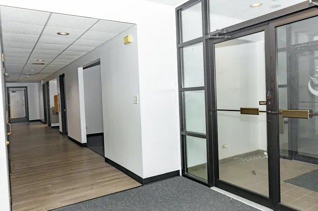 a view of a room with wooden floor