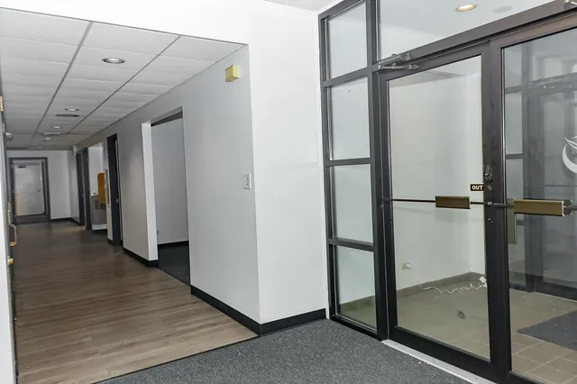 a view of a room with wooden floor