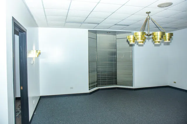 a view of an empty room with a chandelier