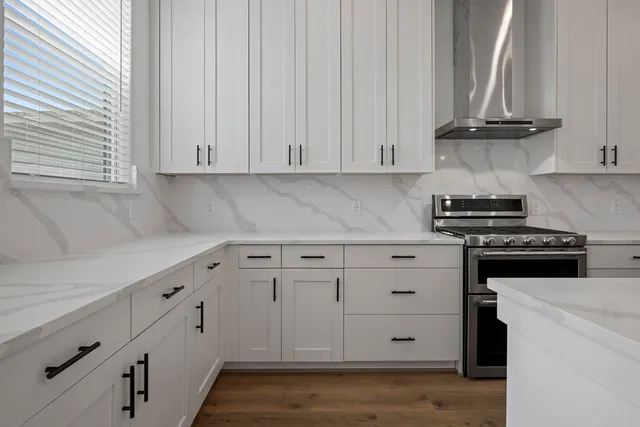 a kitchen with white cabinets and white appliances