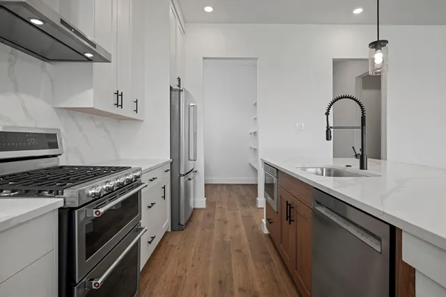 a kitchen with a stove and a sink