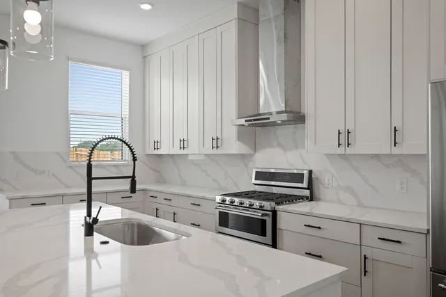 a kitchen with granite countertop a sink and wooden cabinets
