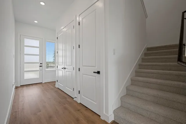 a view of an entryway with wooden floor and staircase