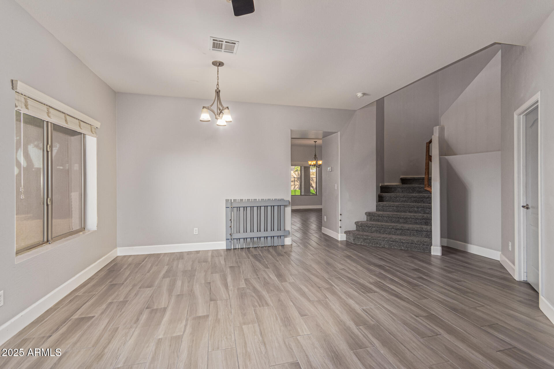 17868 West Charter Oak Road Surprise, AZ 85388 - Photo 14 of 67 a view of a room with wooden floor staircase and a kitchen