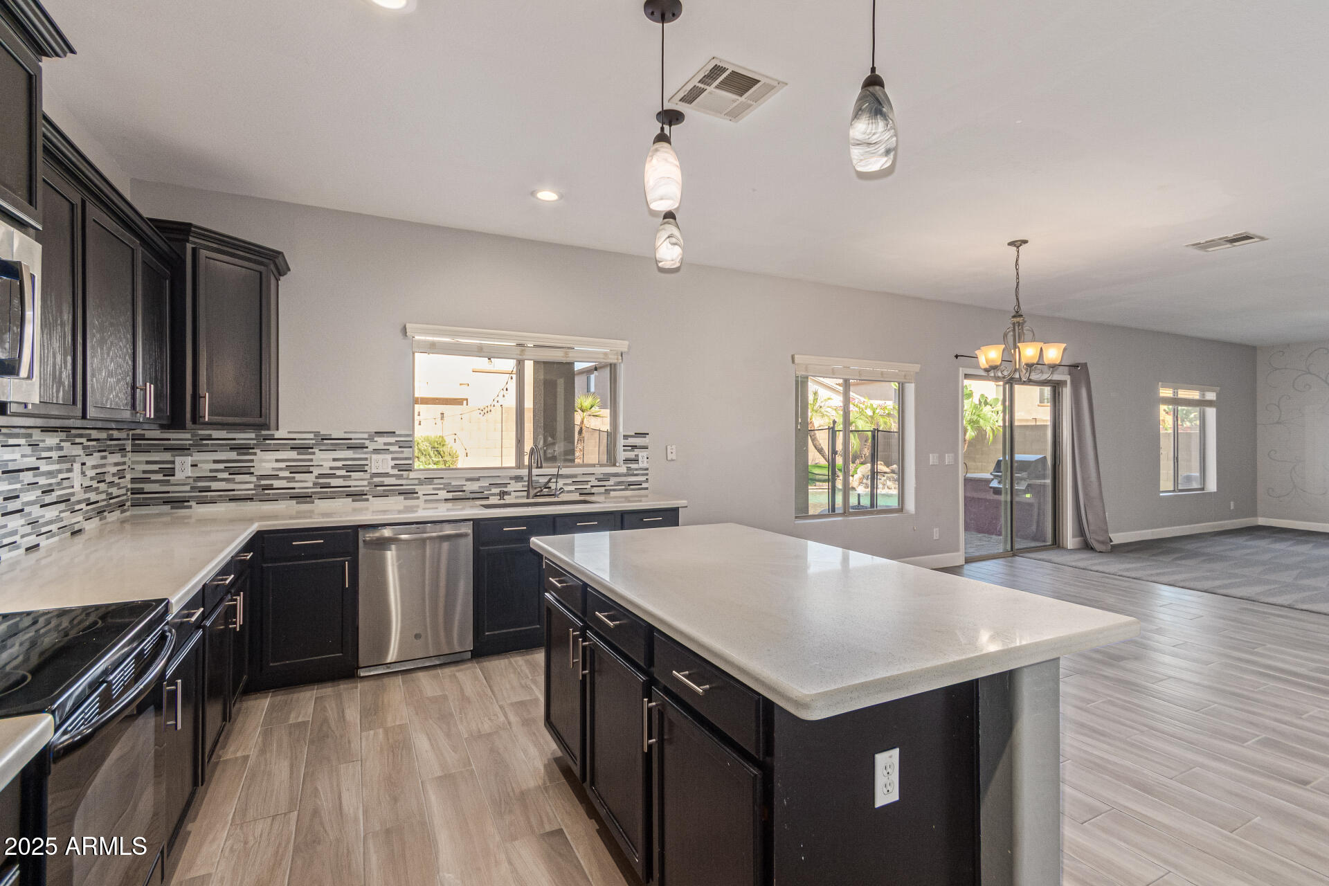 17868 West Charter Oak Road Surprise, AZ 85388 - Photo 21 of 67 a kitchen with center island table and chairs